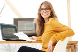 Successful-office-manager-using-vision-software Happy vision infosoft user in office