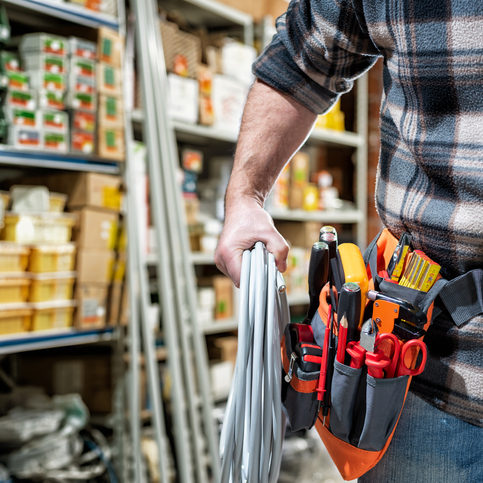 Electrician in the store of electrical components. Electricity. Electrical contractor with electrical materials